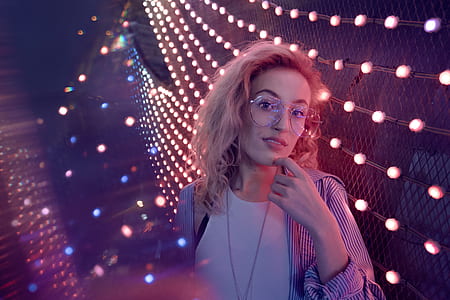 bokeh photograpghy of woman wearing oversize eyeglasses holding her chin thumbnail