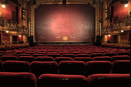 red gang chairs in front of stage thumbnail