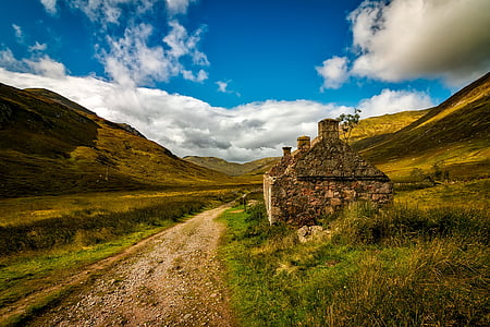 landscape photography of rocky road surrounded by mountains thumbnail