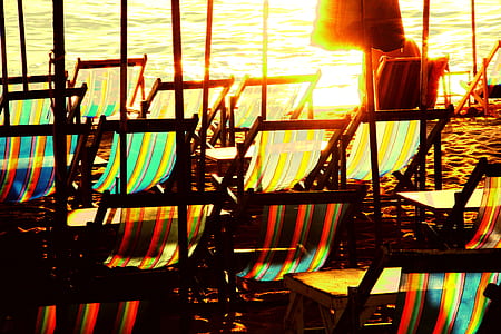 assorted-color lounge chair near sea at daytime thumbnail