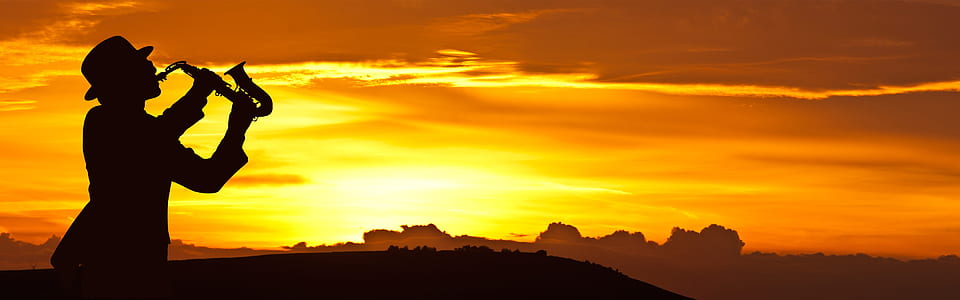 silhouette of person playing saxophone thumbnail