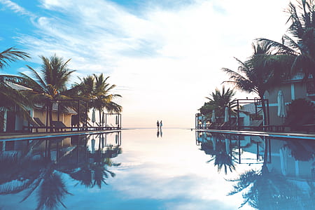 two person standing near swimming pool thumbnail