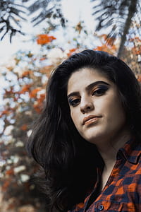 woman wearing orange and blue flannel shirt thumbnail