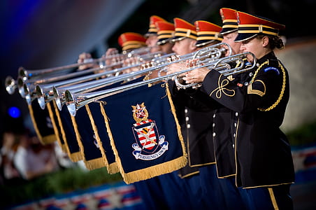 People in Uniform Using a Trumpet Instrument With Blue and Yellow Flag Under thumbnail