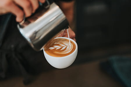 person pouring espresso coffee on white teacup thumbnail