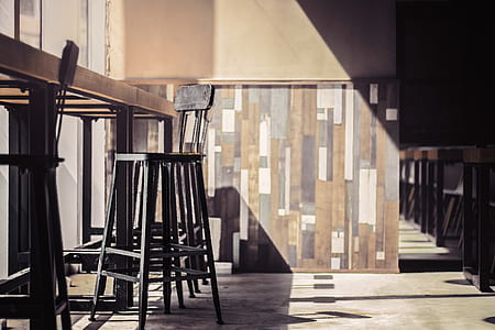 black metal bar chair near on table inside concrete room close-up photo thumbnail