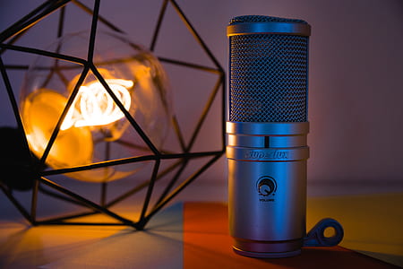 silver condenser microphone beside black table lamp thumbnail