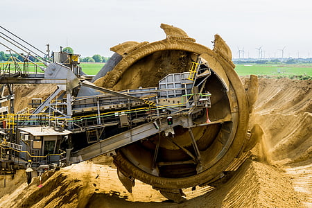 gray industrial machine at cultivates sand at daytime thumbnail