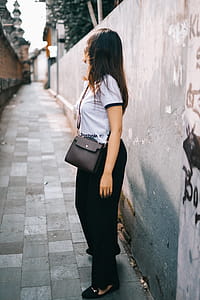 Woman Wearing Black and White T-shirt and Black Pants thumbnail