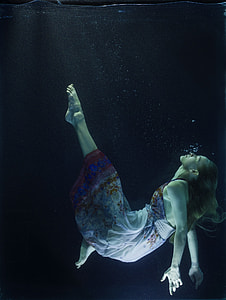 woman in white dress under water photography thumbnail