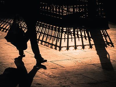 silhouette of person walking on tiles thumbnail
