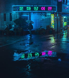 person standing holding opened umbrella thumbnail