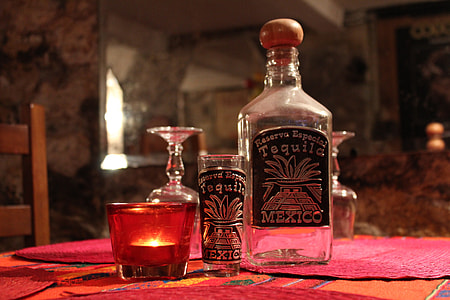 closeup photo of bottle with shot glass thumbnail
