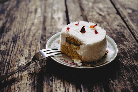 round sliced cake on white ceramic plate beside gray stainless steel fork thumbnail