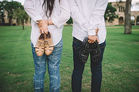 man and woman holding pair of shoes thumbnail