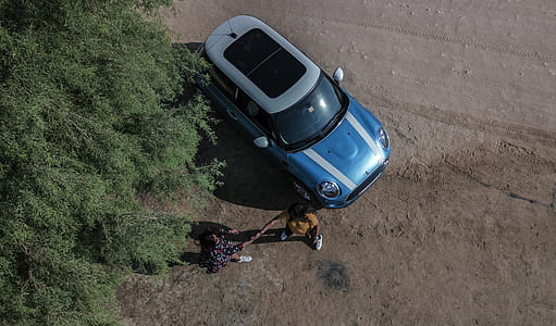 Two People Standing Beside Mini Cooper thumbnail