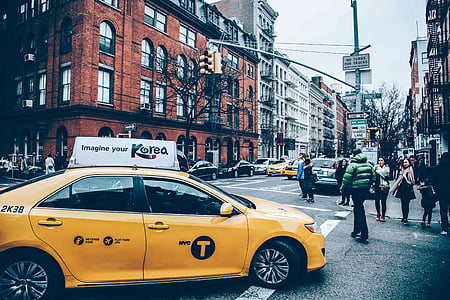 yellow sedan in middle of cross road thumbnail