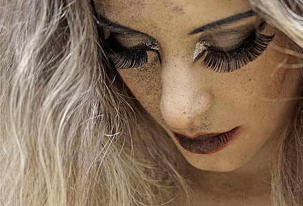 woman in red lipstick and false eyelashes thumbnail