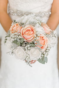 bride holding white and pink flower bouquet thumbnail