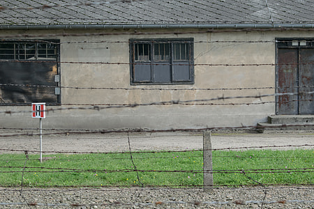 barbwire fence near concrete house thumbnail