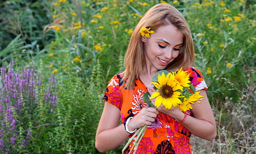 closeup photo of woman holding sunflower thumbnail
