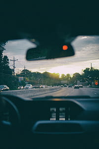 person travelling on road during golden hour thumbnail