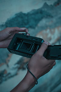 person holding black camera thumbnail
