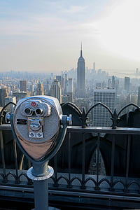 silver binoculars pointing high-rise buildings thumbnail