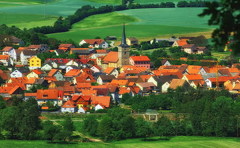 brown houses near green trees at daytime thumbnail