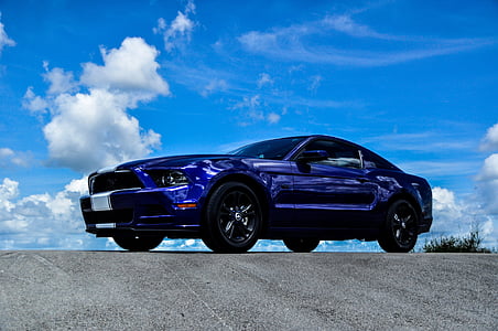 purple coupe on gray concrete road thumbnail