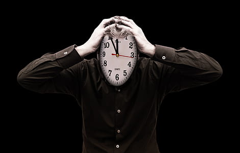 person holding wall clock thumbnail