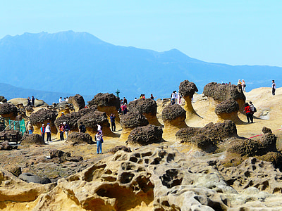 aerial photo of group of people standing on rock formations thumbnail