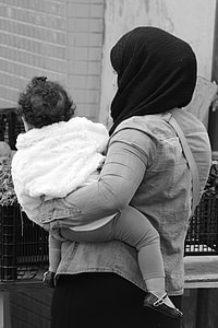 woman carrying baby thumbnail