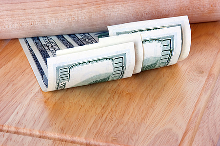U.S.A. banknotes on top of brown table thumbnail