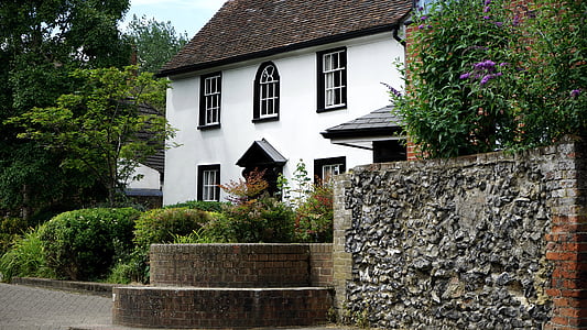 white and brown concrete house surrounded with green plants thumbnail