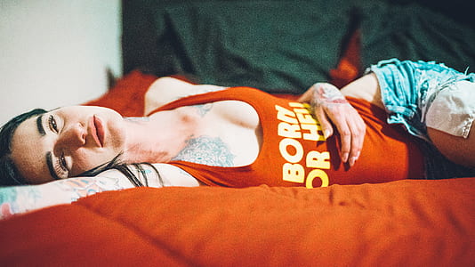 woman laying on red bed thumbnail