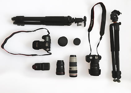 flat-lay photography of two DSLR cameras and tripods thumbnail