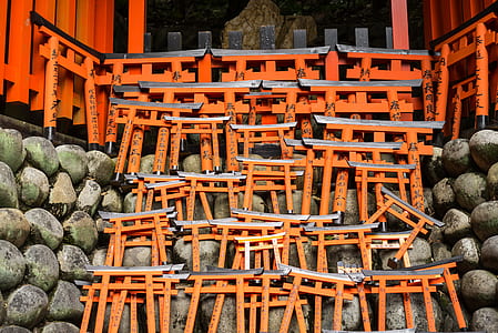 orange wooden tori gates on gray wall thumbnail