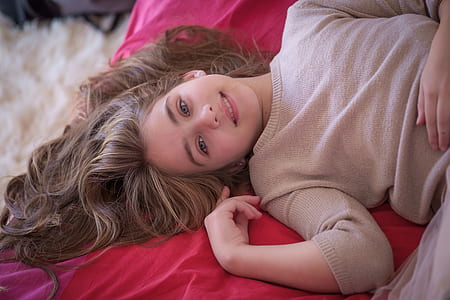 girl in red dress lying on red blanket thumbnail