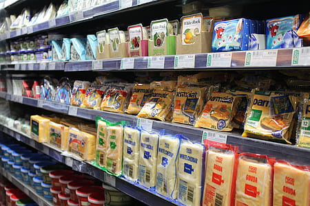 gondola shelf filled with varieties of cheese products thumbnail