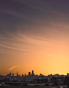 landscape photography of buildings under cirrus clouds thumbnail