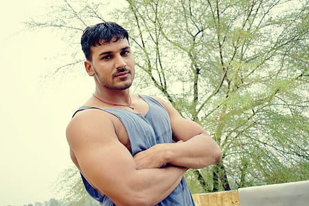 man standing beside tree thumbnail