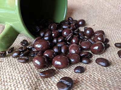 Coffee beans and chocolate spilling out of  mug thumbnail