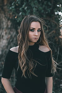 woman wearing black cold-shoulder top standing near tree thumbnail