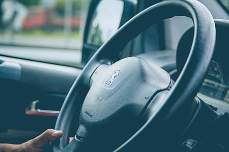 person holding steering wheel thumbnail
