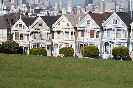 piled houses beside green grass field thumbnail