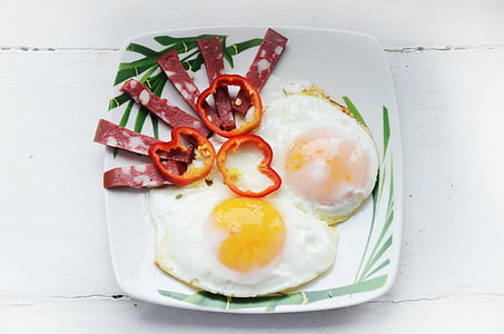 fried egg, beacon, and slice of bell peppers on white plate thumbnail
