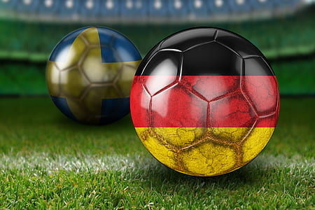 two soccer balls on grass thumbnail