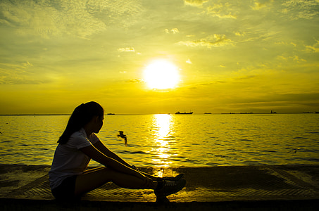 woman wearing white t-shirt near body of water thumbnail