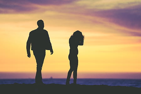 silhouette photo of two standing people during golden hour thumbnail